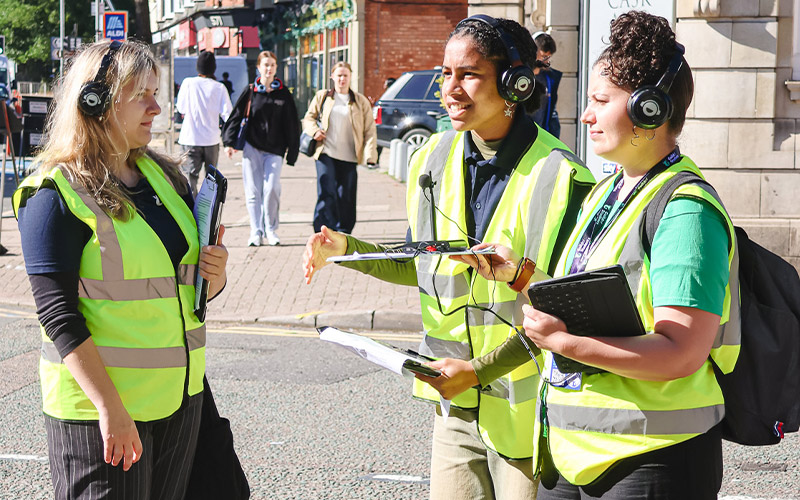 a photo of student staff in high vis in the community