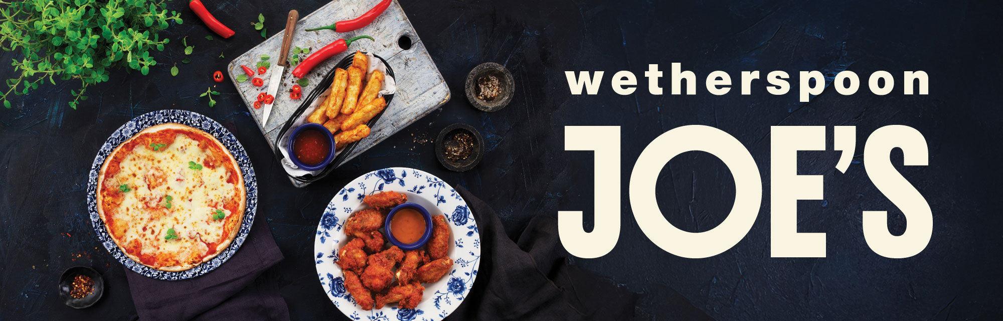 A banner with a selection of food on plates such as wings that says Wetherspoon Joe's