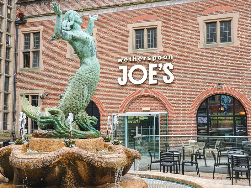 an image of the outside of joe's with the mermaid at the front