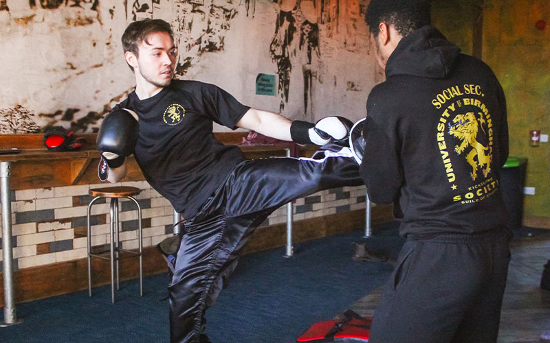 a photo of a student kick boxing
