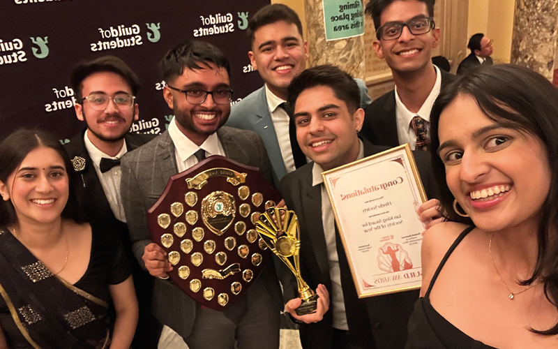 a photo of students with a guild award