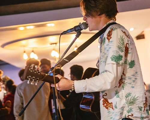 a singer playing guitair in joes bar