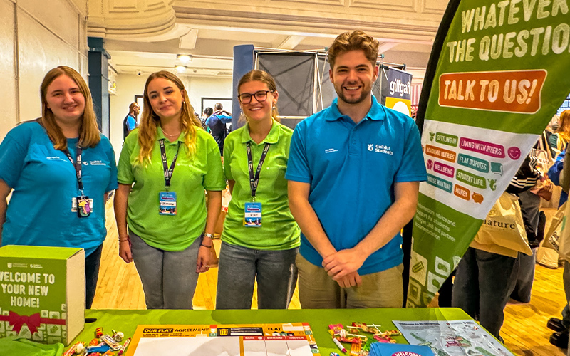 guild staff members at a stall at welcome