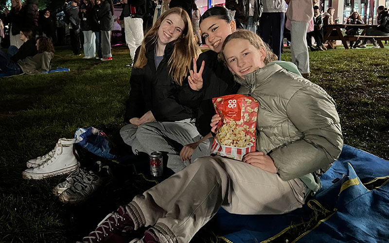 students sat down at open air cinema