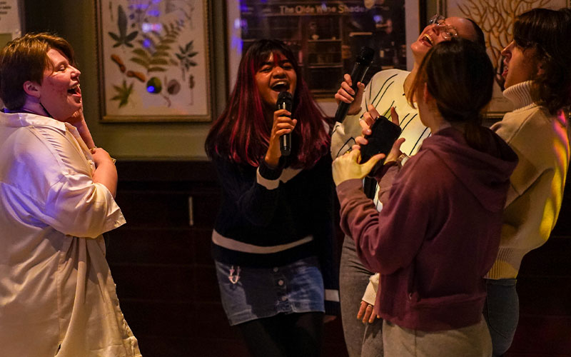 students singing karaoke at joes bar