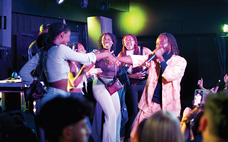 students with a singer on stage