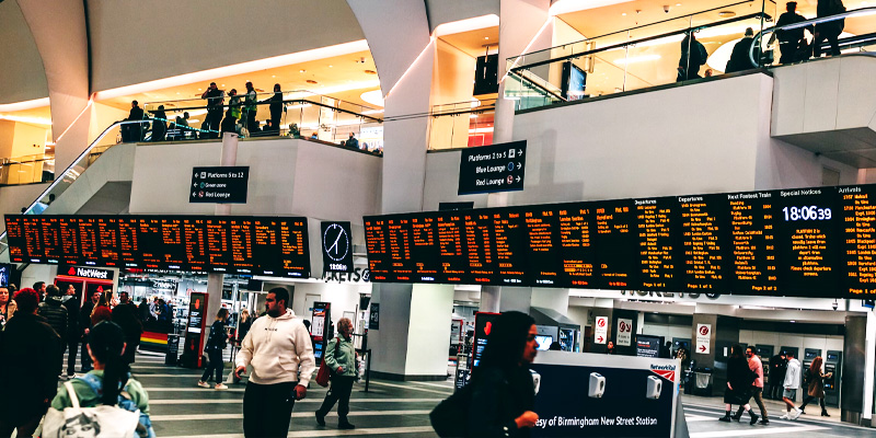 a photo of train boards at new street station