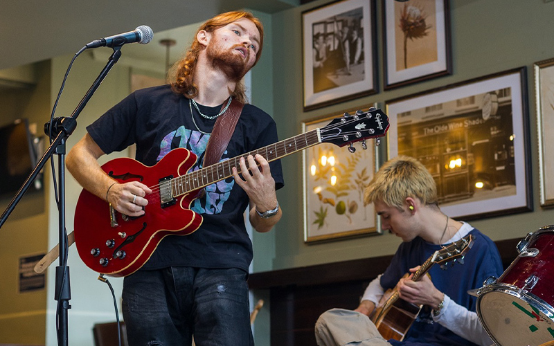 students playing a guitar