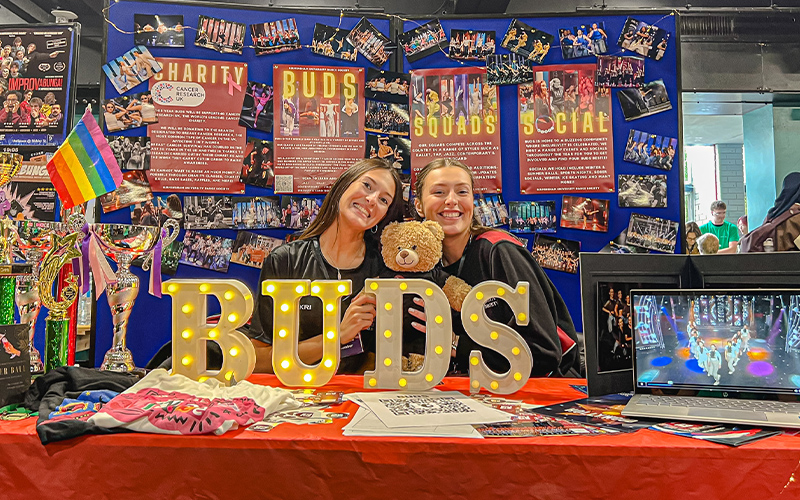 students at a BUDS stand at a fair