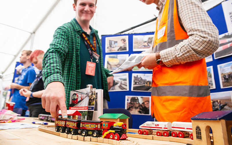 students playing with a train set