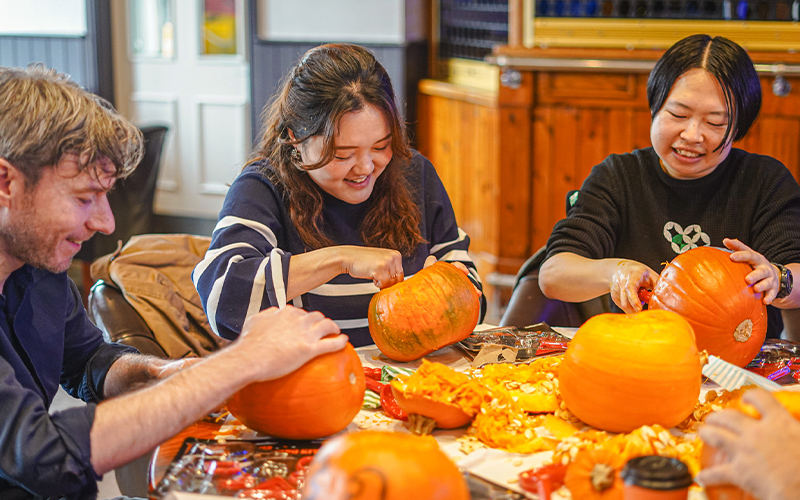 a group of students at a guild pumpkin event