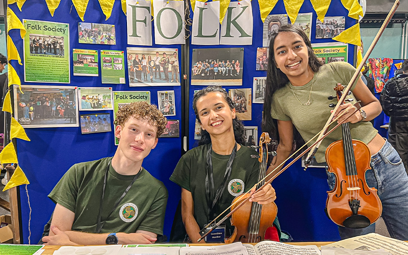 students at a folk stand at societies fair