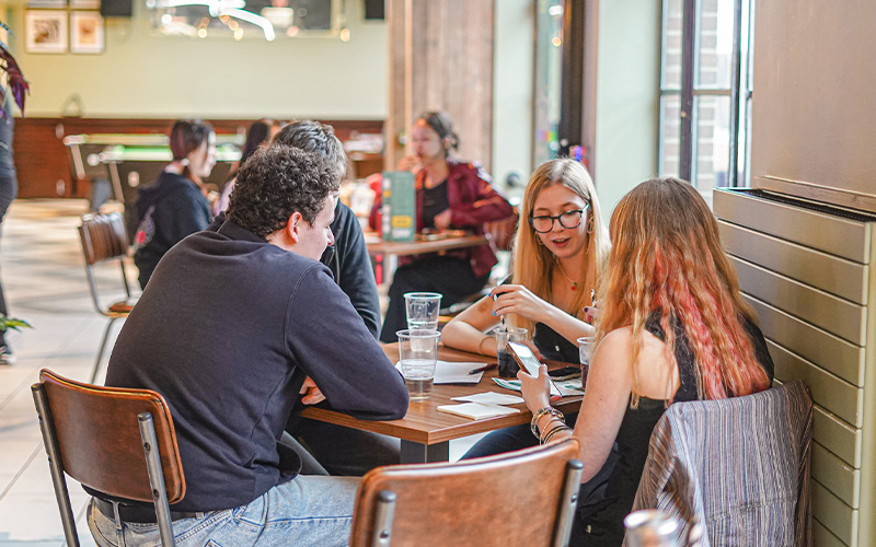 a photo of students studying in joes bar